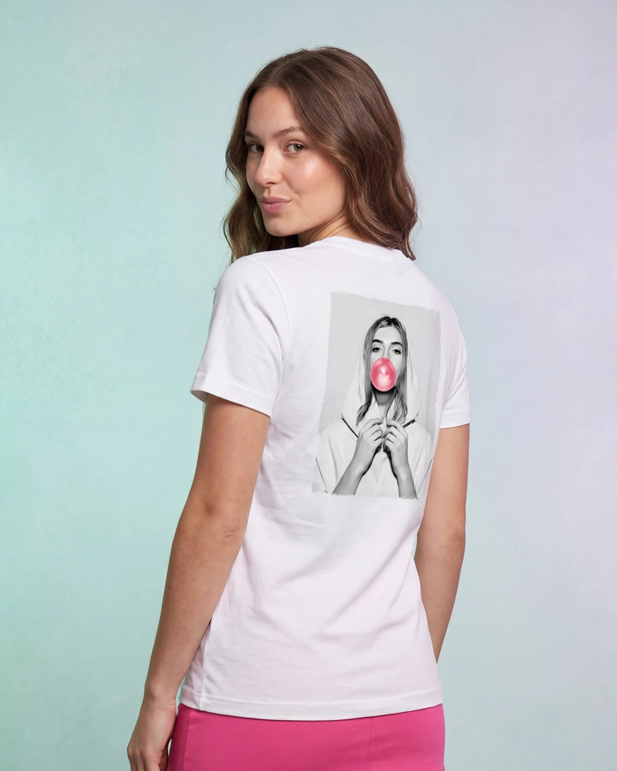 Model wearing white t-shirt with bubblegum portrait graphic, back view