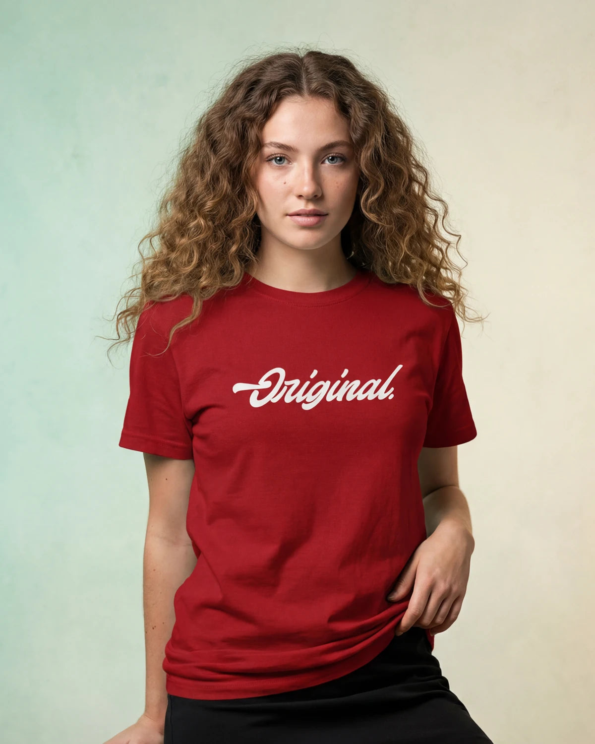 Model wearing red t-shirt with Original. text, front view