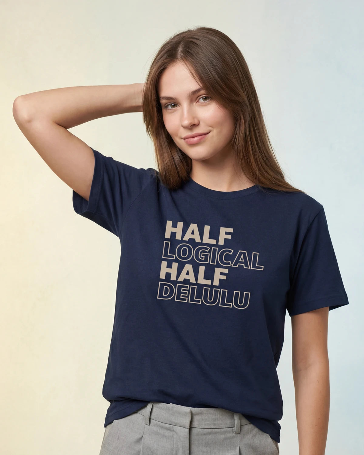 Model wearing navy t-shirt with HALF LOGICAL HALF DELULU text, front view
