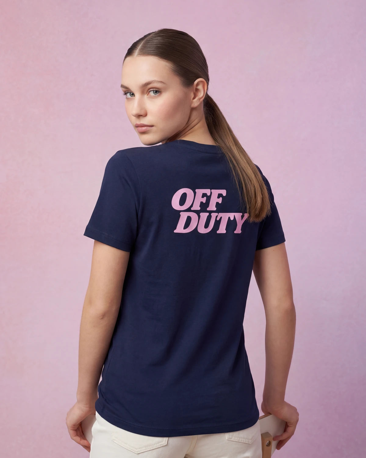 Model wearing navy t-shirt with OFF DUTY text, back view
