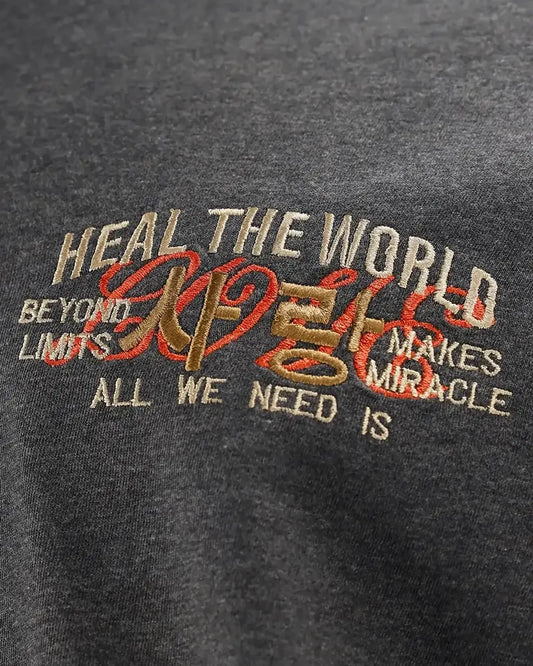 Charcoal melange T-shirt with embroidered text graphic, close-up detail view
