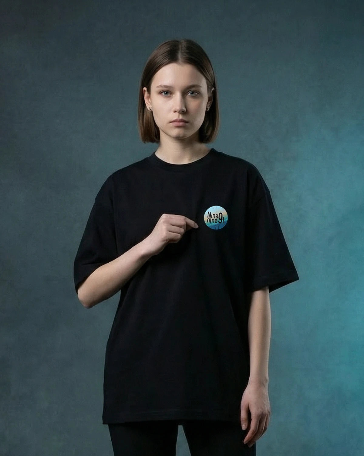 Female model wearing Mystic Dance oversized T-shirt with Nine9nineT chest graphic, front view
