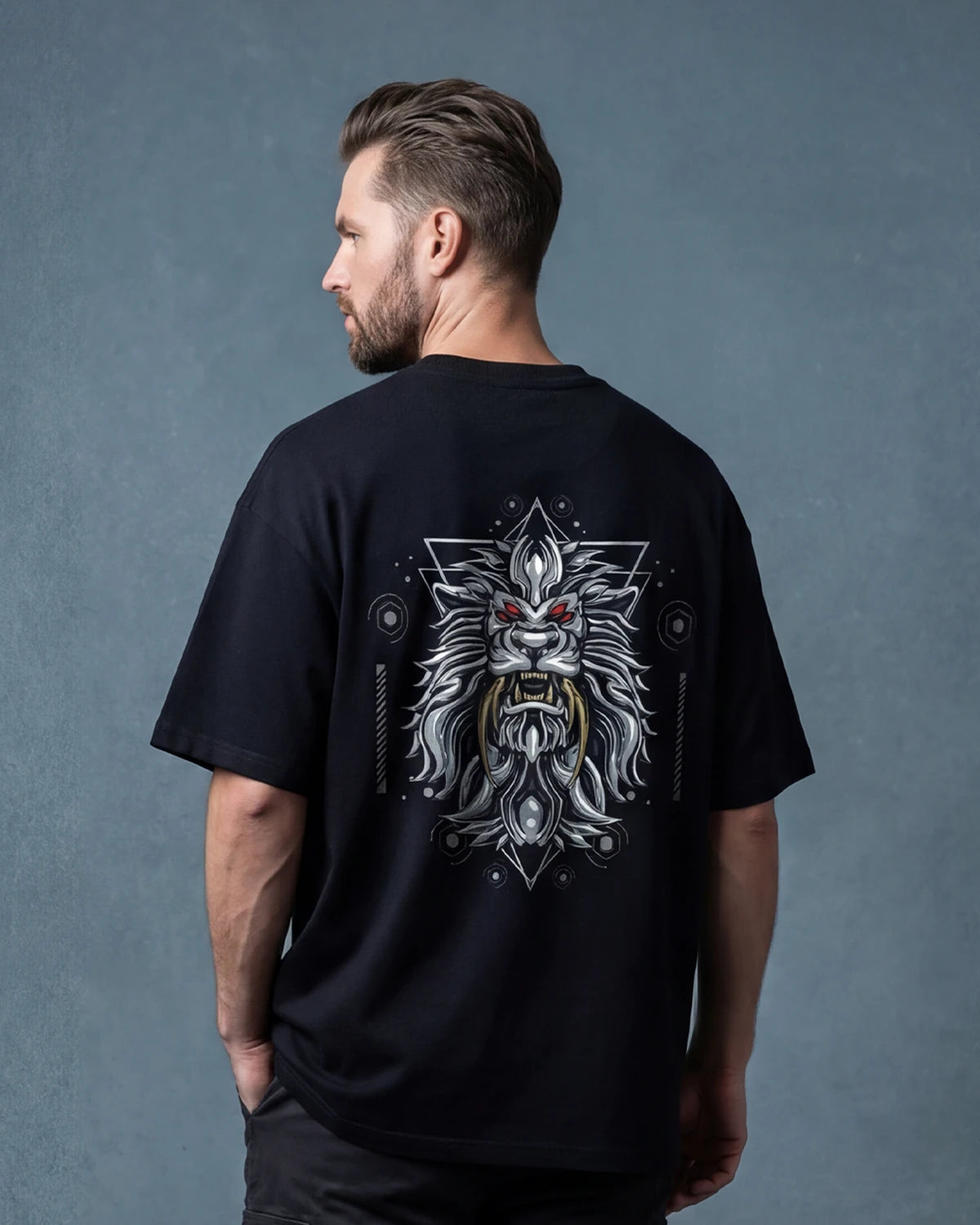 Male model wearing Sabertooth oversized T-shirt with back lion graphic, back view