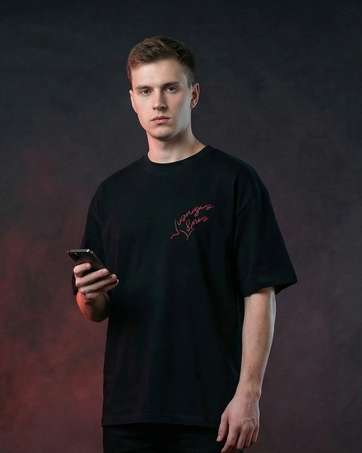 Male model wearing Faces Unbound oversized T-shirt with chest text graphic, front view
