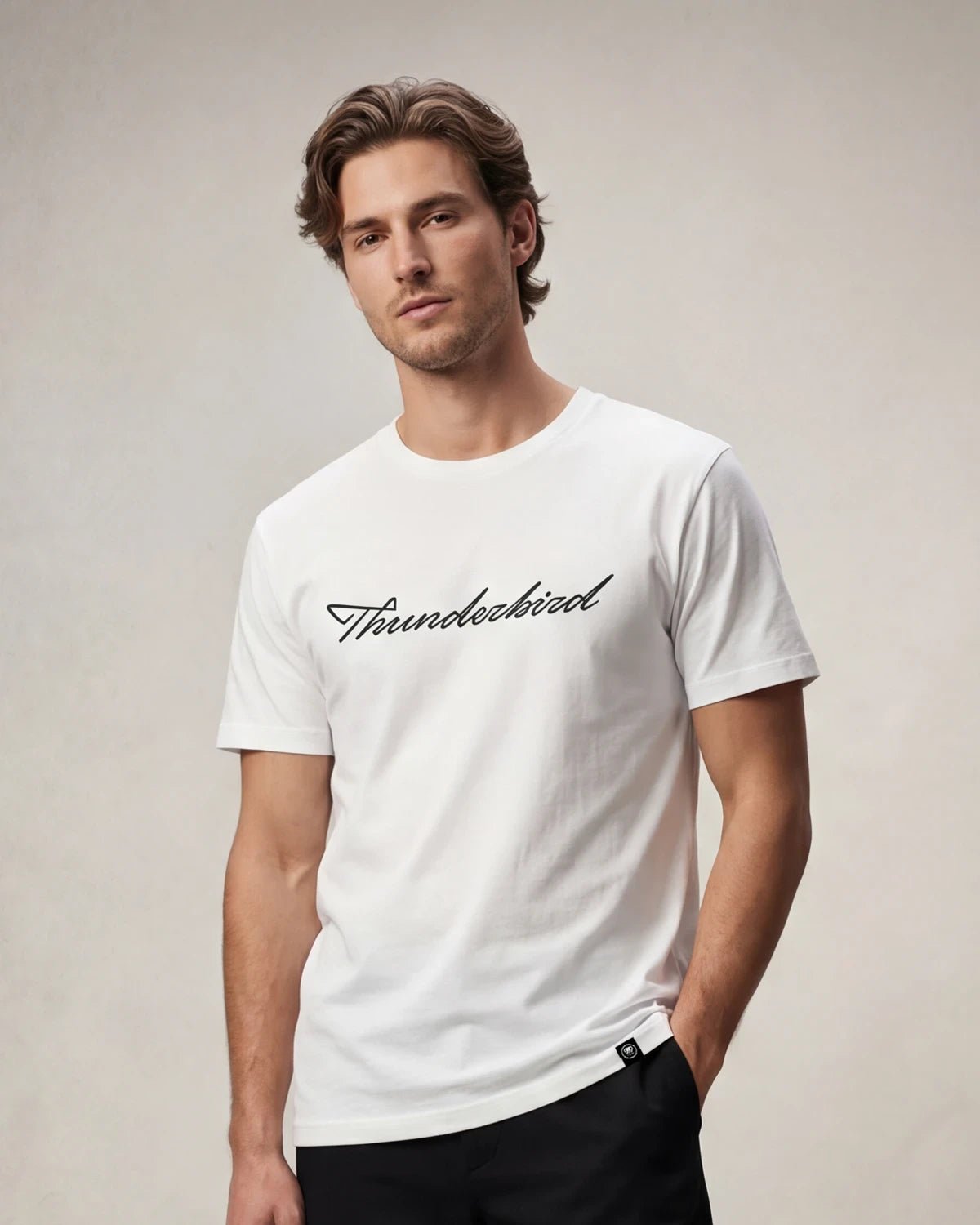 Male model wearing white T-shirt with Thunderbird script text, front view