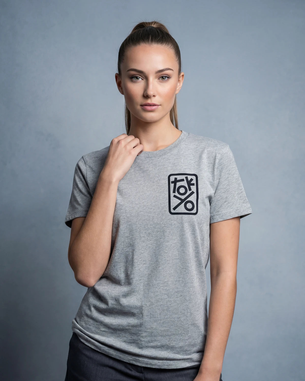 Model wearing grey melange t-shirt with TOKYO chest graphic, front view model shot