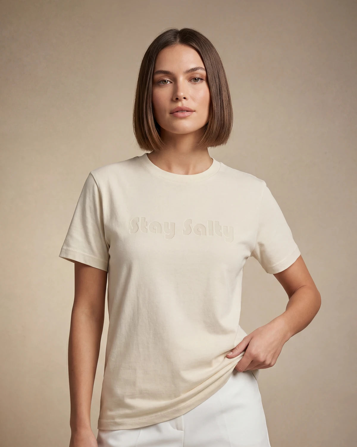 Model wearing natural t-shirt with Stay Salty text, front view model shot
