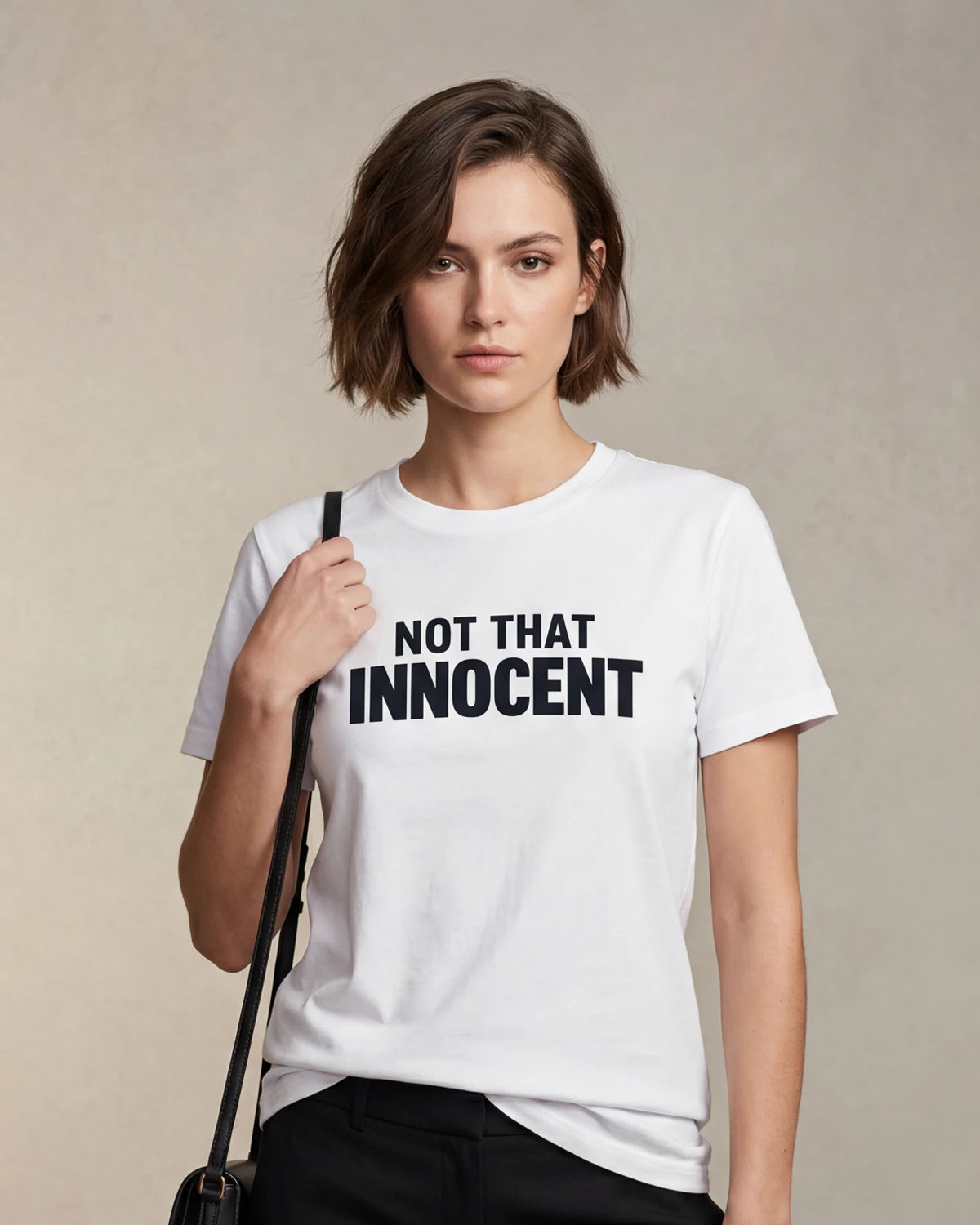 Model wearing white t-shirt with NOT THAT INNOCENT text, front view model shot
