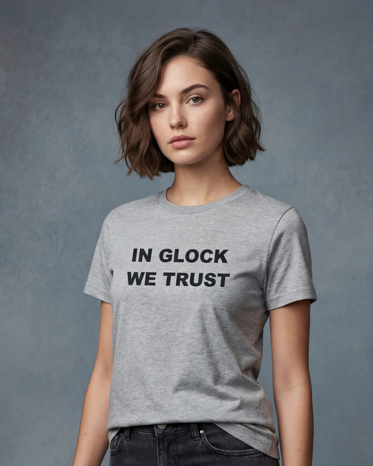 Model wearing grey melange t-shirt with IN GLOCK WE TRUST text, front view model shot
