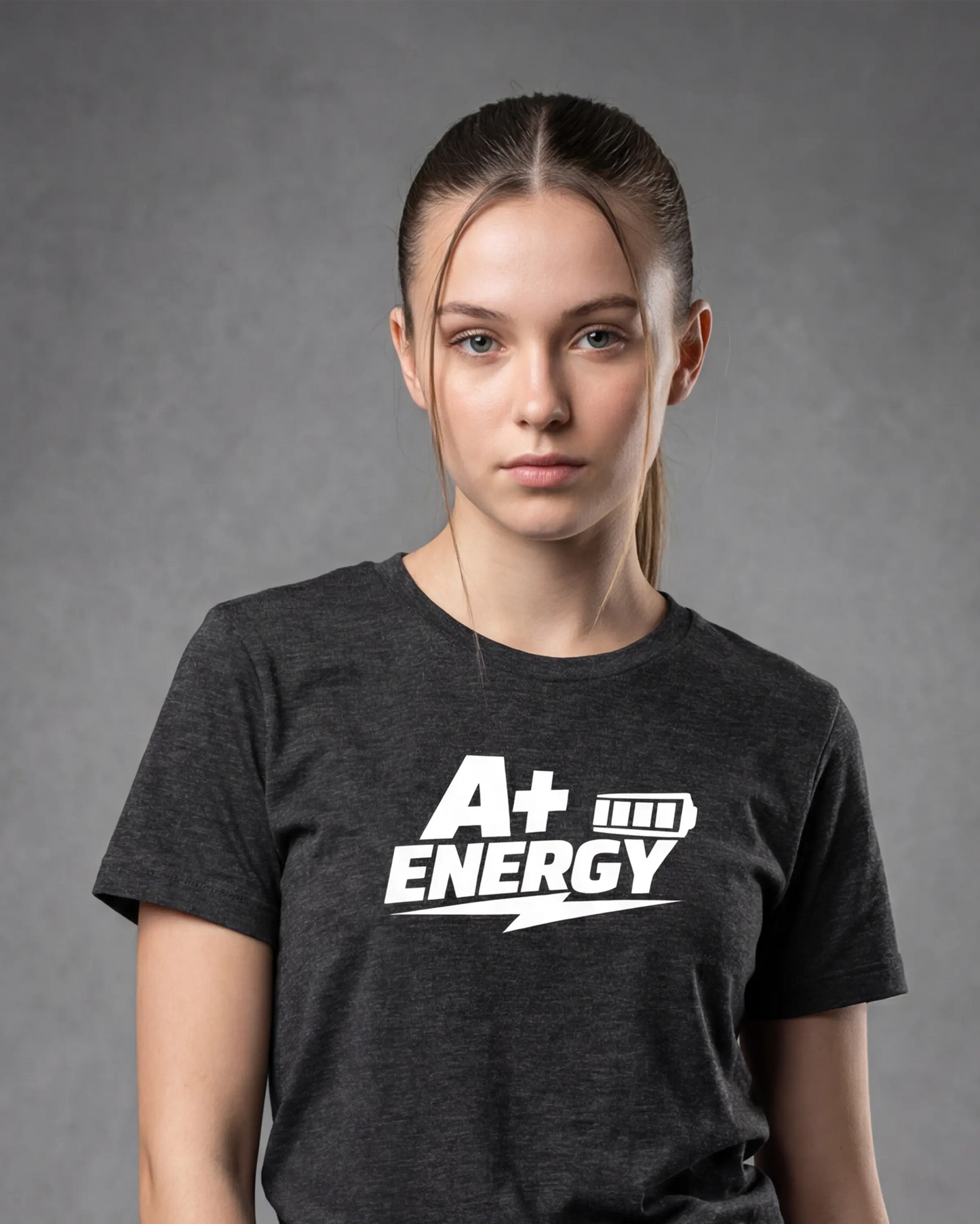Model wearing charcoal melange t-shirt with A+ ENERGY graphic, close-up front view