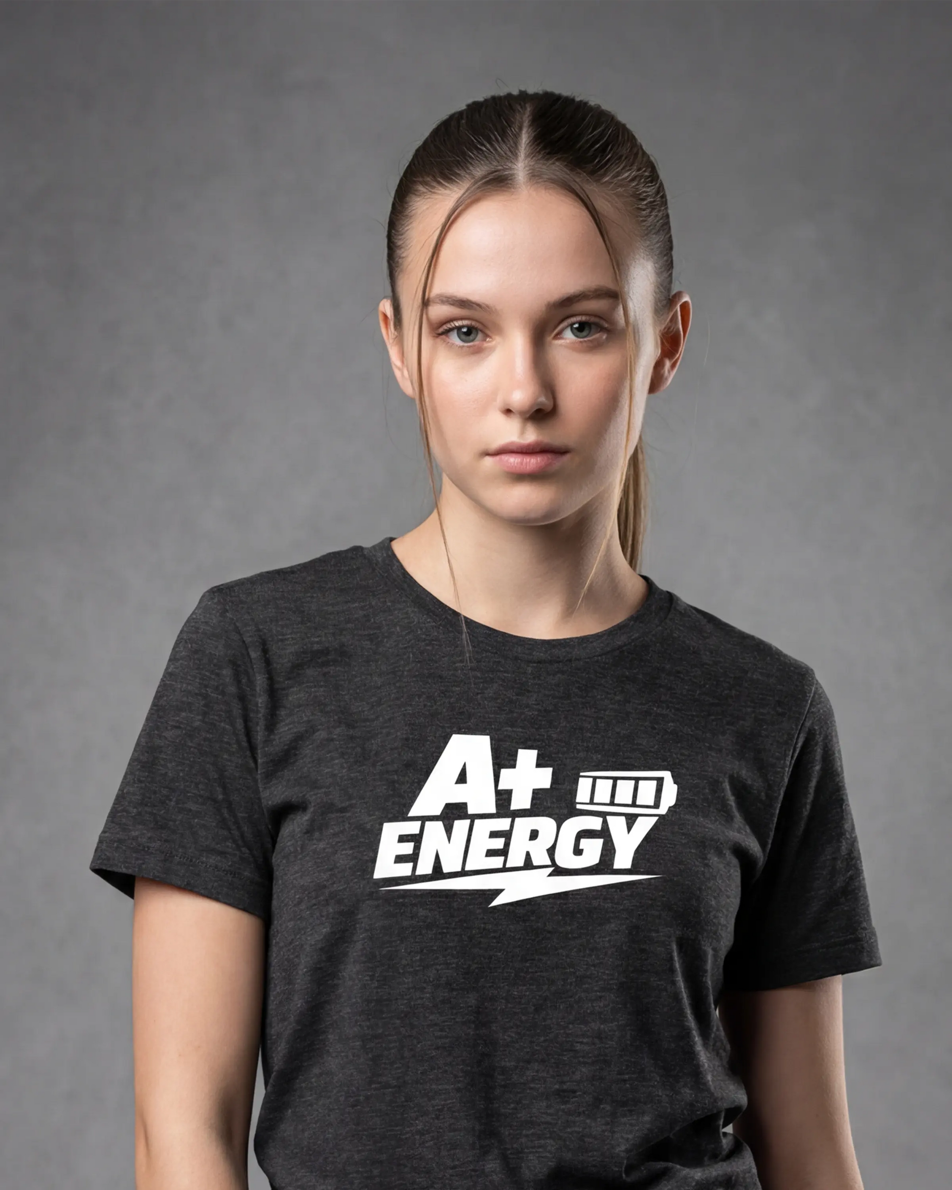 Model wearing charcoal melange t-shirt with A+ ENERGY graphic, close-up front view