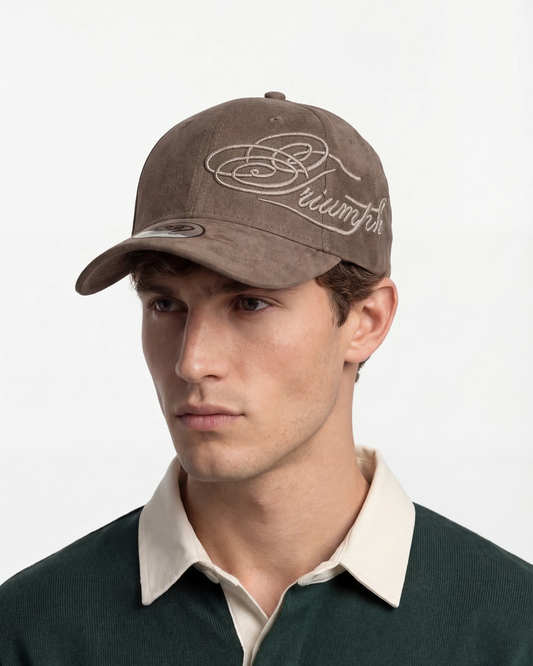 Male model wearing brown Triumph suede cap, side angle view