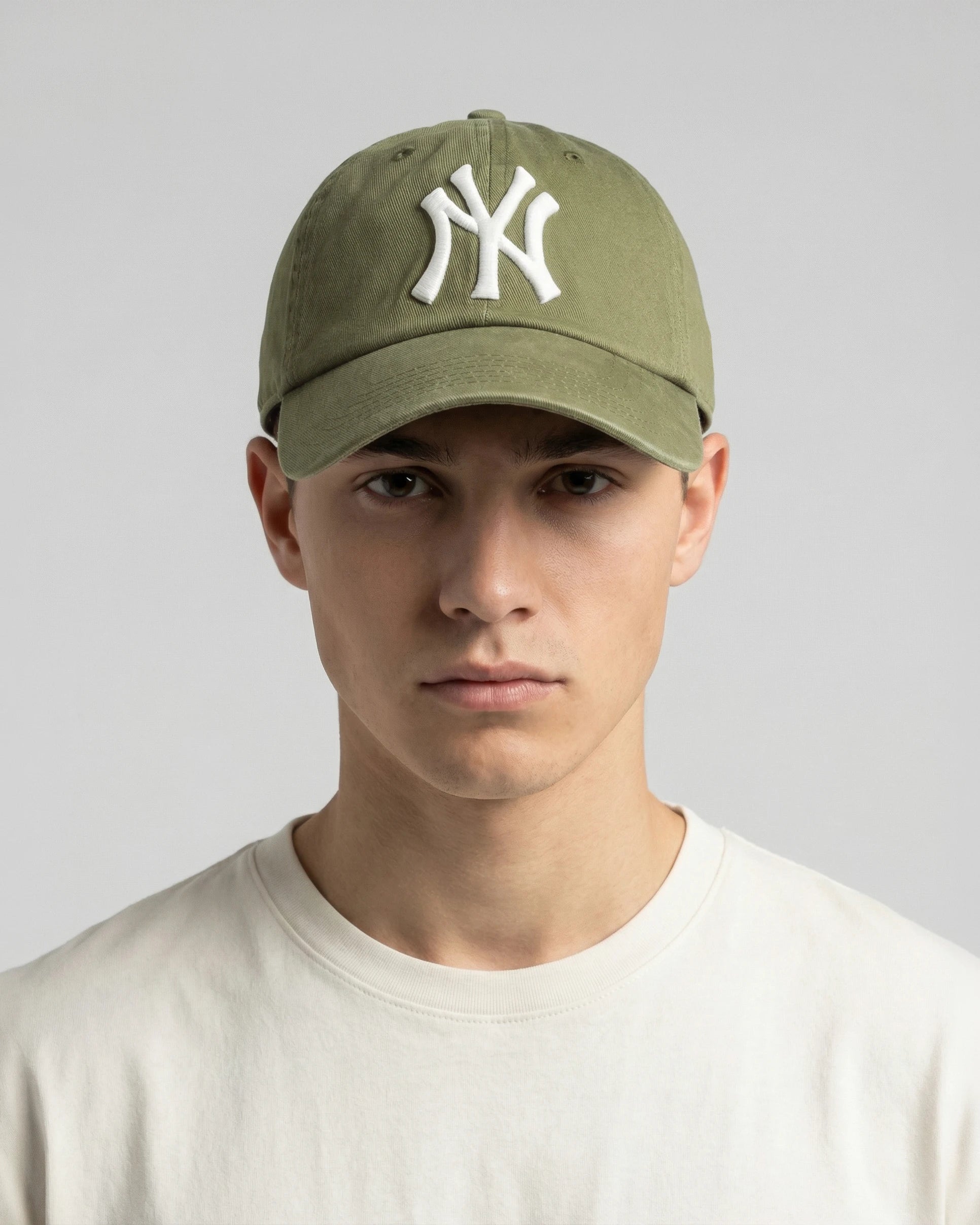 Male model wearing olive NY cap, front view