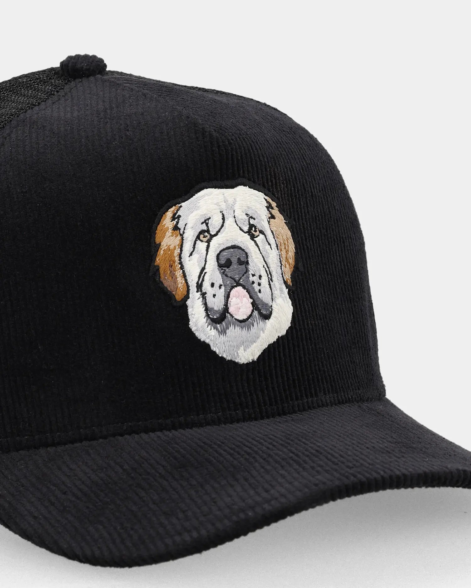 Black trucker cap with Mastiff patch, angled front detail view