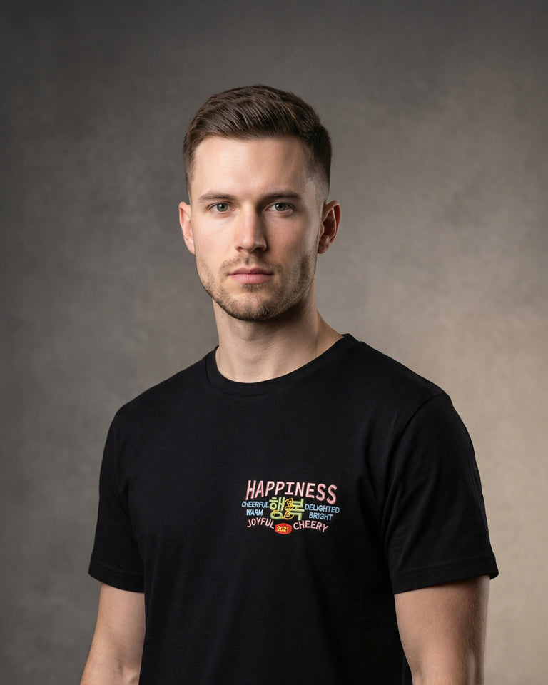Male wearing black t-shirt with Happiness chest embroidery, portrait model shot